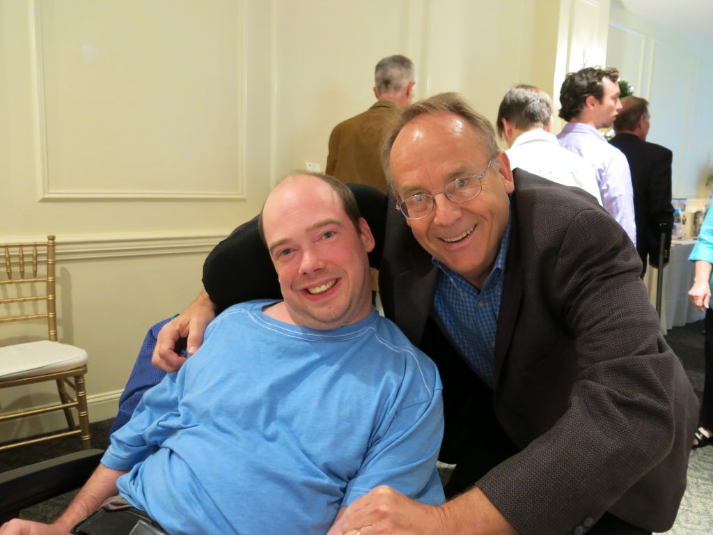 A male advocate stands behind his male partner at our annual Theater Event