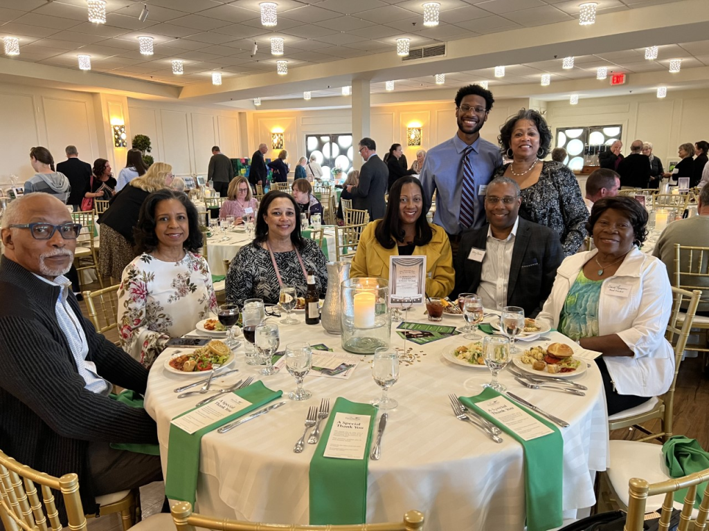 Theater Event attendees sit at a table ready to eat their dinner