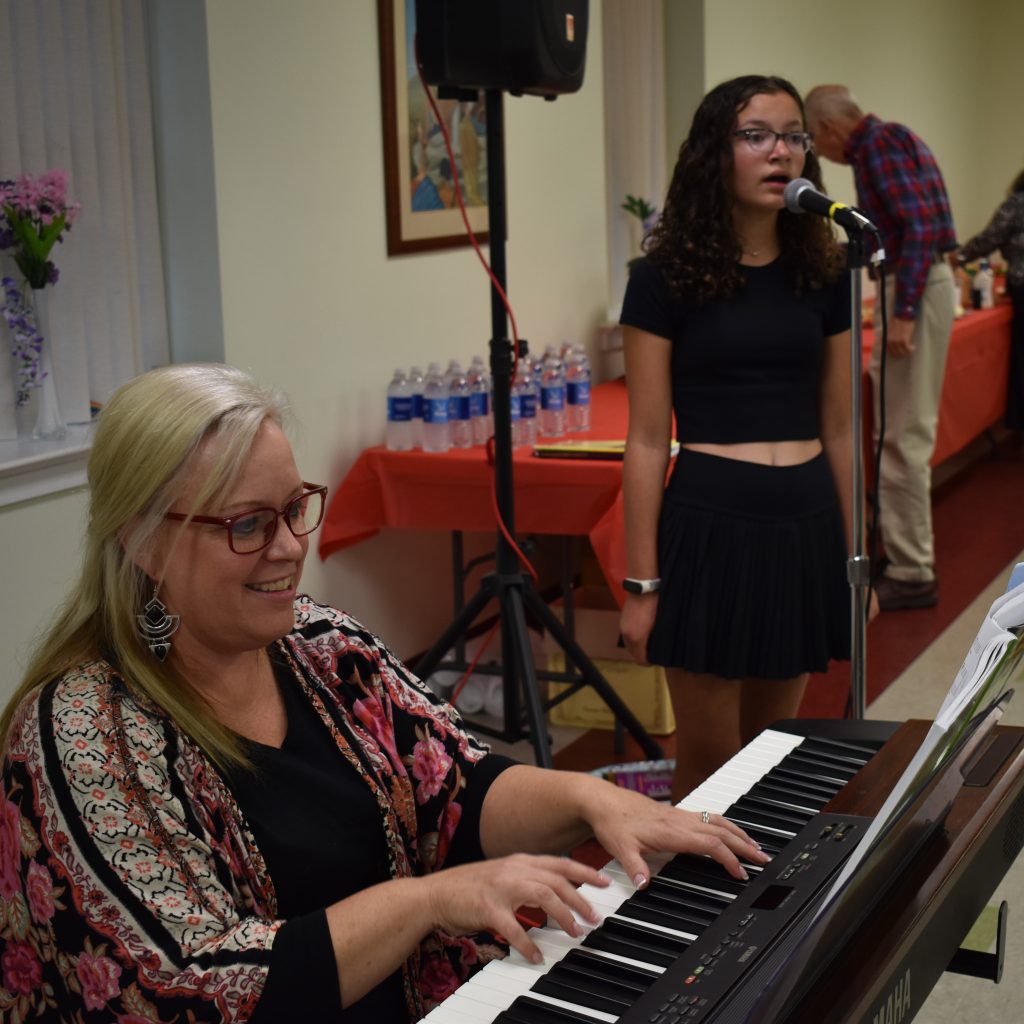 Christine Brown, one of our coordinators, plays piano and accompanies a student who is singing